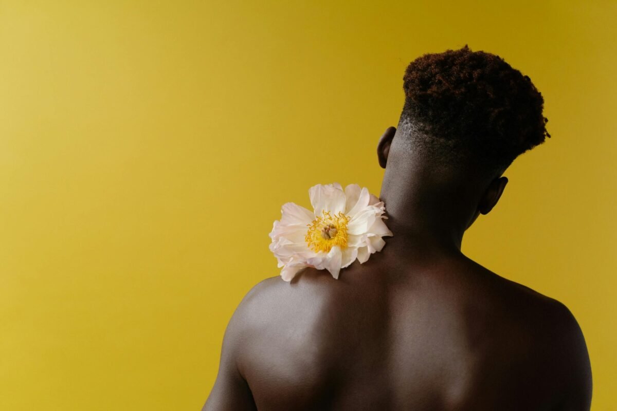 Man holding flower on shoulder